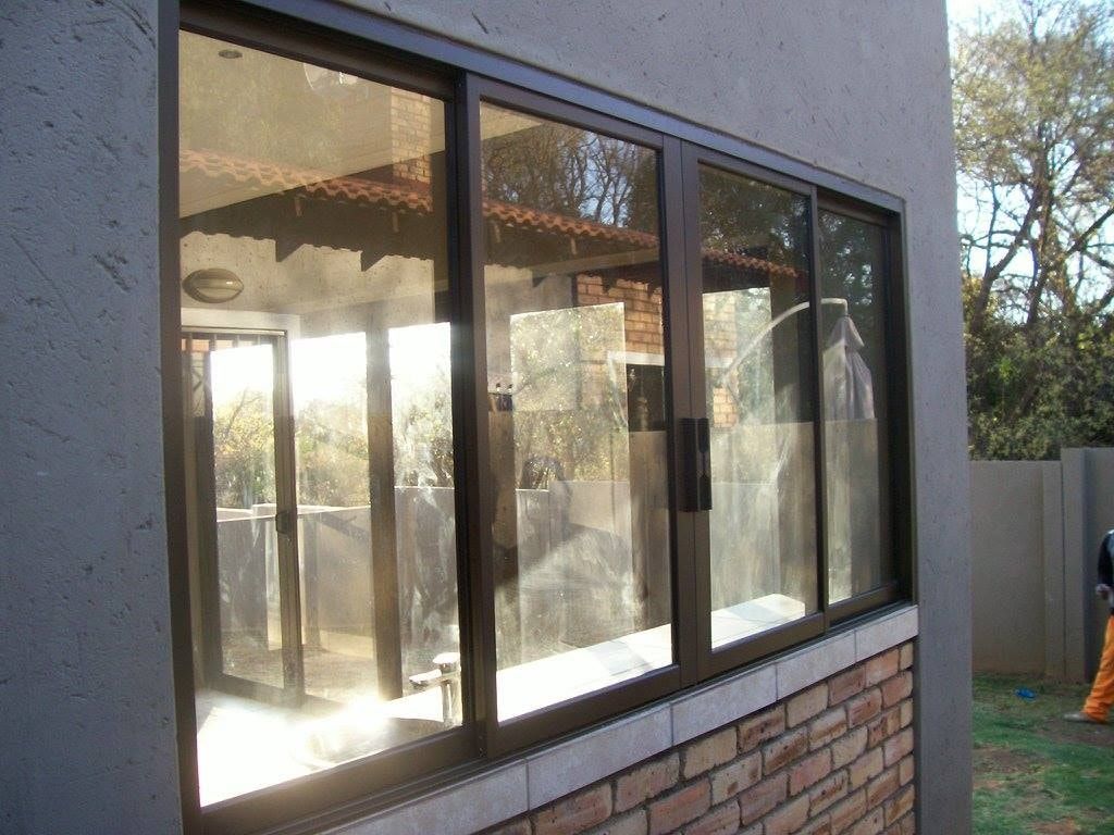 Bronze aluminium sliding unit fitted in a plastered wall